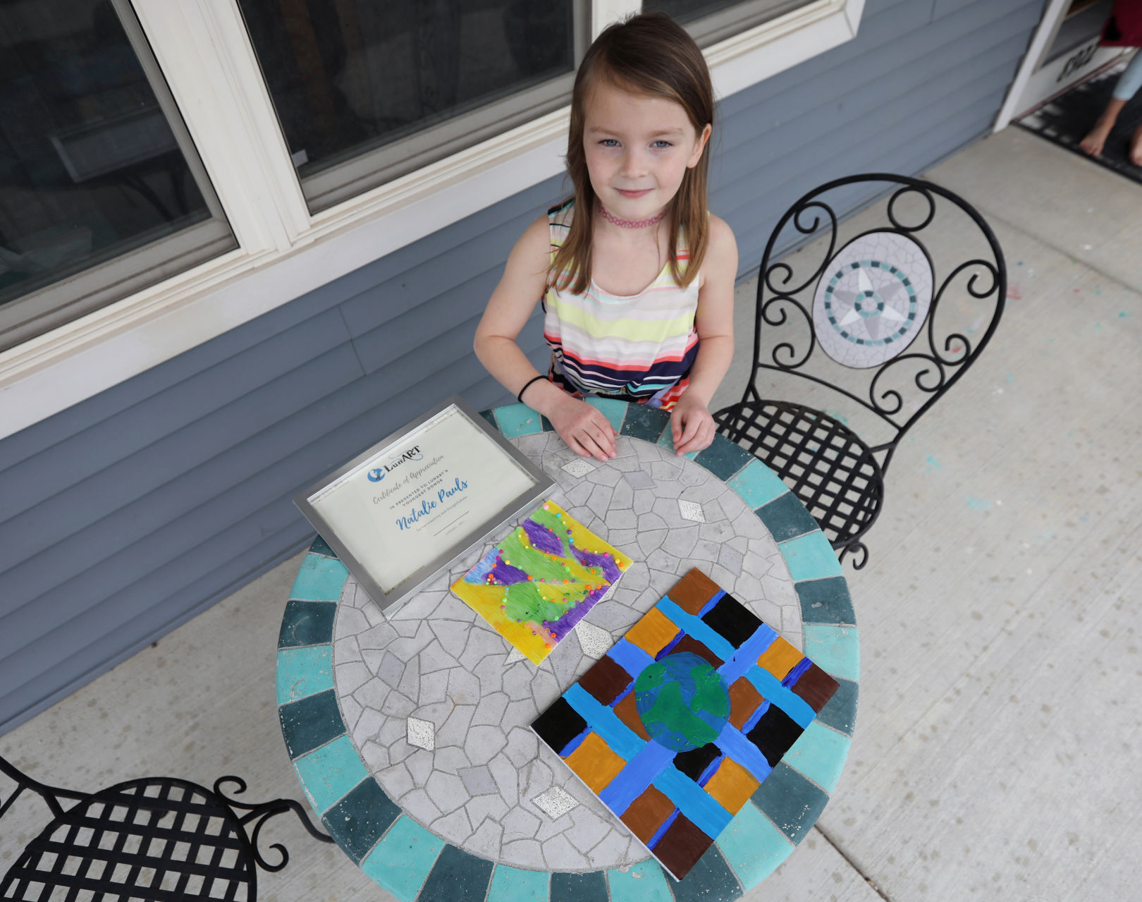 Natalie Pauls with her artwork for LunART Youth Art Celebration